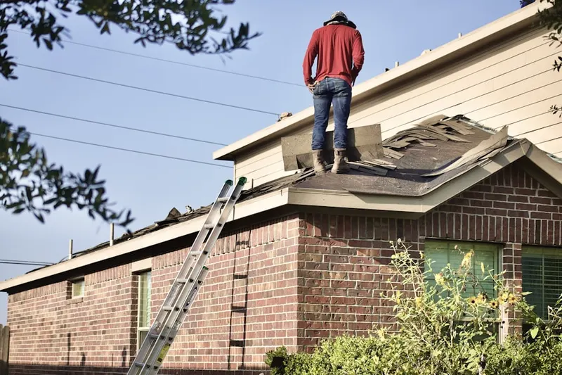 Professional roofer working on a residential roof in Milmay